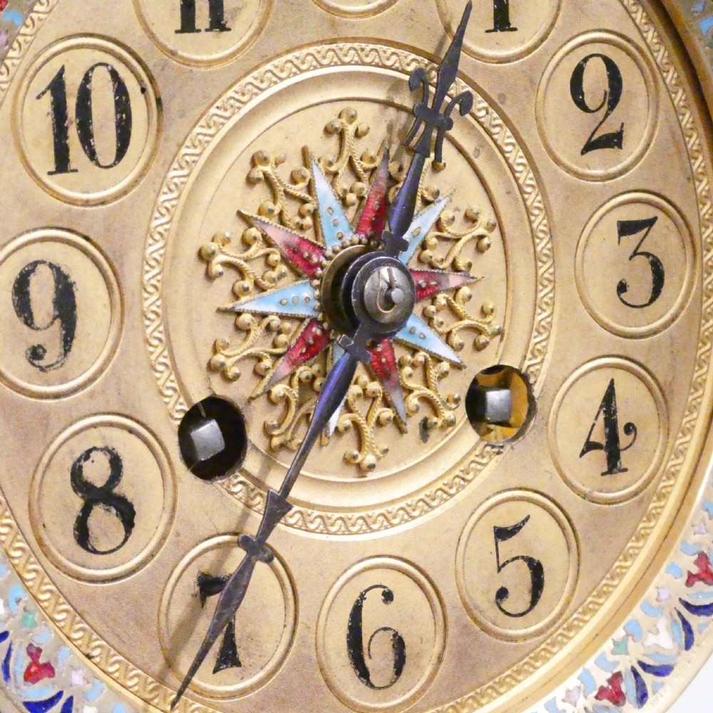A late nineteenth-century French four-glass mantel clock featuring a green onyx base and top, champleve enamel borders, and a visible mercury pendulum. View IV
