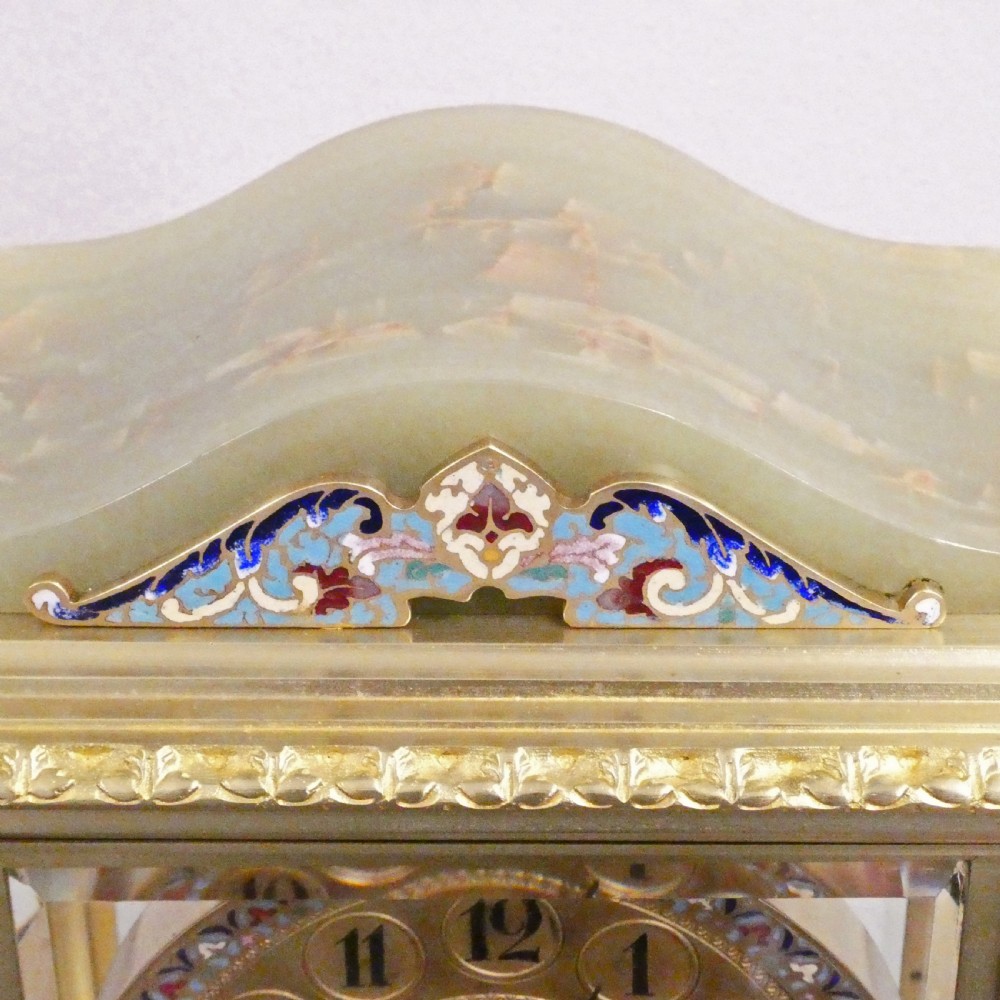 A late nineteenth-century French four-glass mantel clock featuring a green onyx base and top, champleve enamel borders, and a visible mercury pendulum. View XII