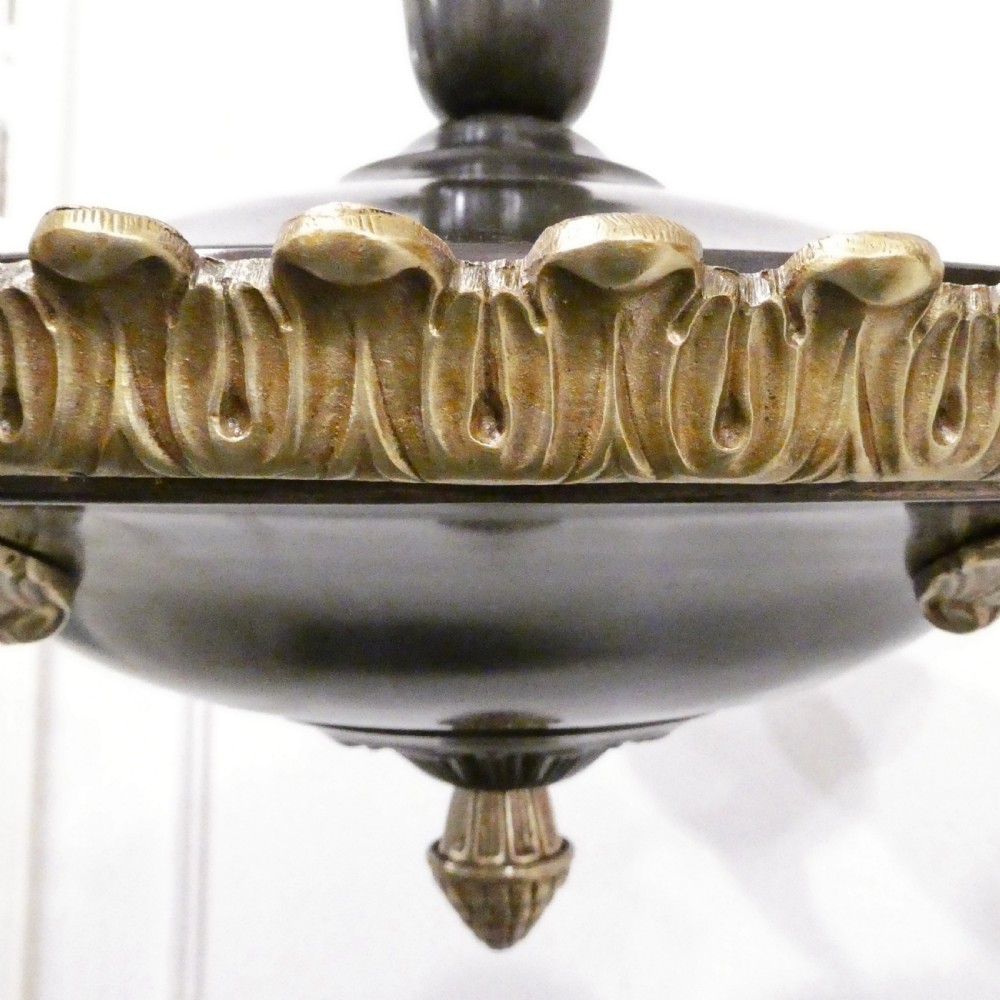 An Art Deco bronze chandelier featuring carved alabaster shade cups suspended from a corded stem with decorative tassel detail. View VII