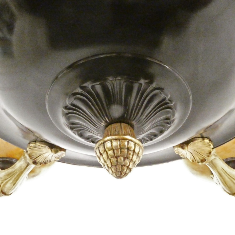 An Art Deco bronze chandelier featuring carved alabaster shade cups suspended from a corded stem with decorative tassel detail. View XI