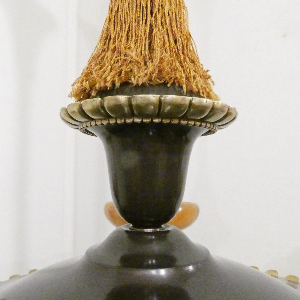 An Art Deco bronze chandelier featuring carved alabaster shade cups suspended from a corded stem with decorative tassel detail. View XIII