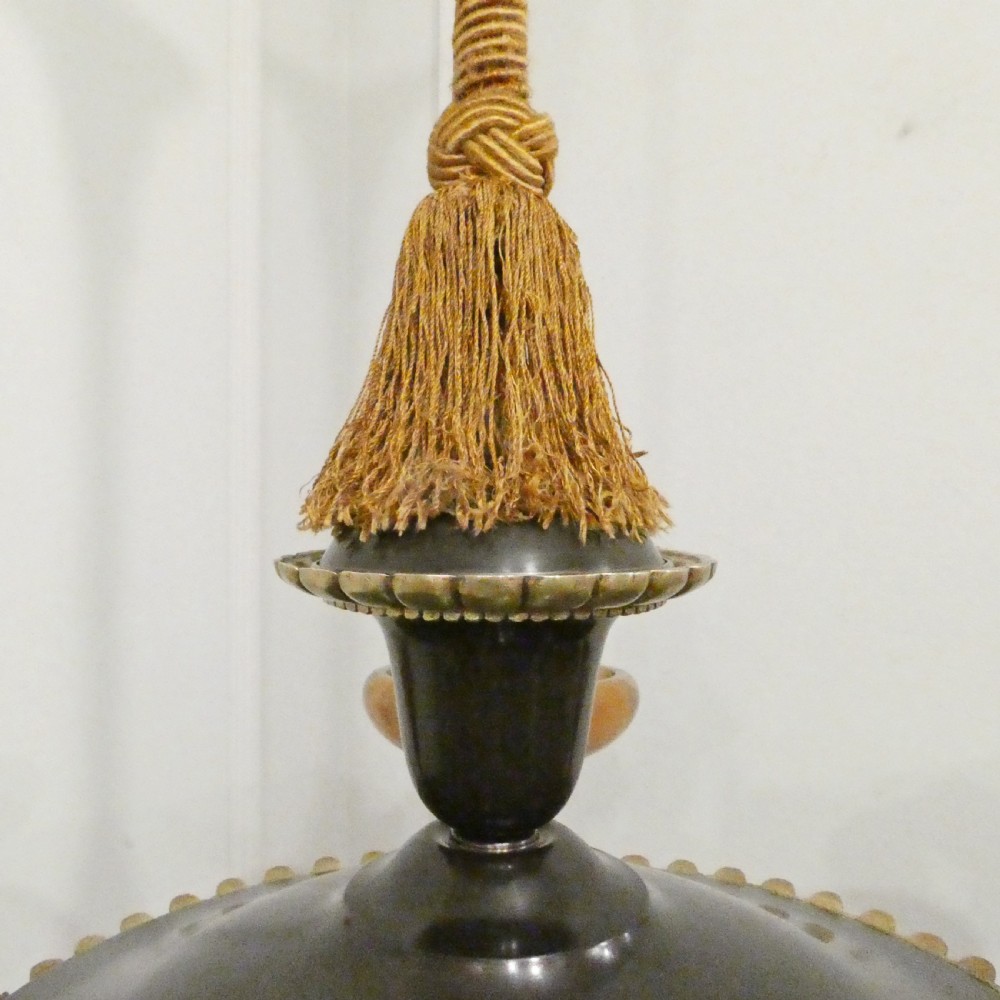 An Art Deco bronze chandelier featuring carved alabaster shade cups suspended from a corded stem with decorative tassel detail. View XIV