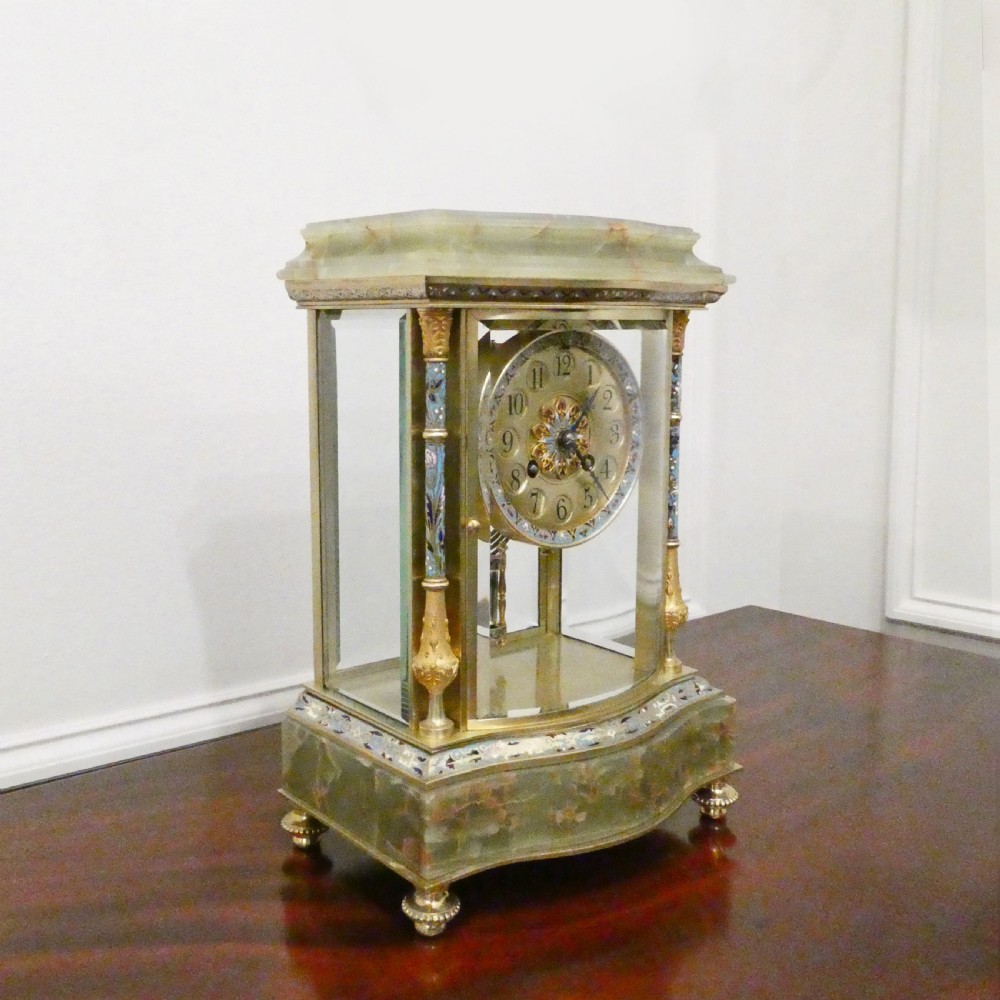 An antique French four-glass mantel clock featuring green onyx bases, champleve enamel columns, and a visible brass movement. View II