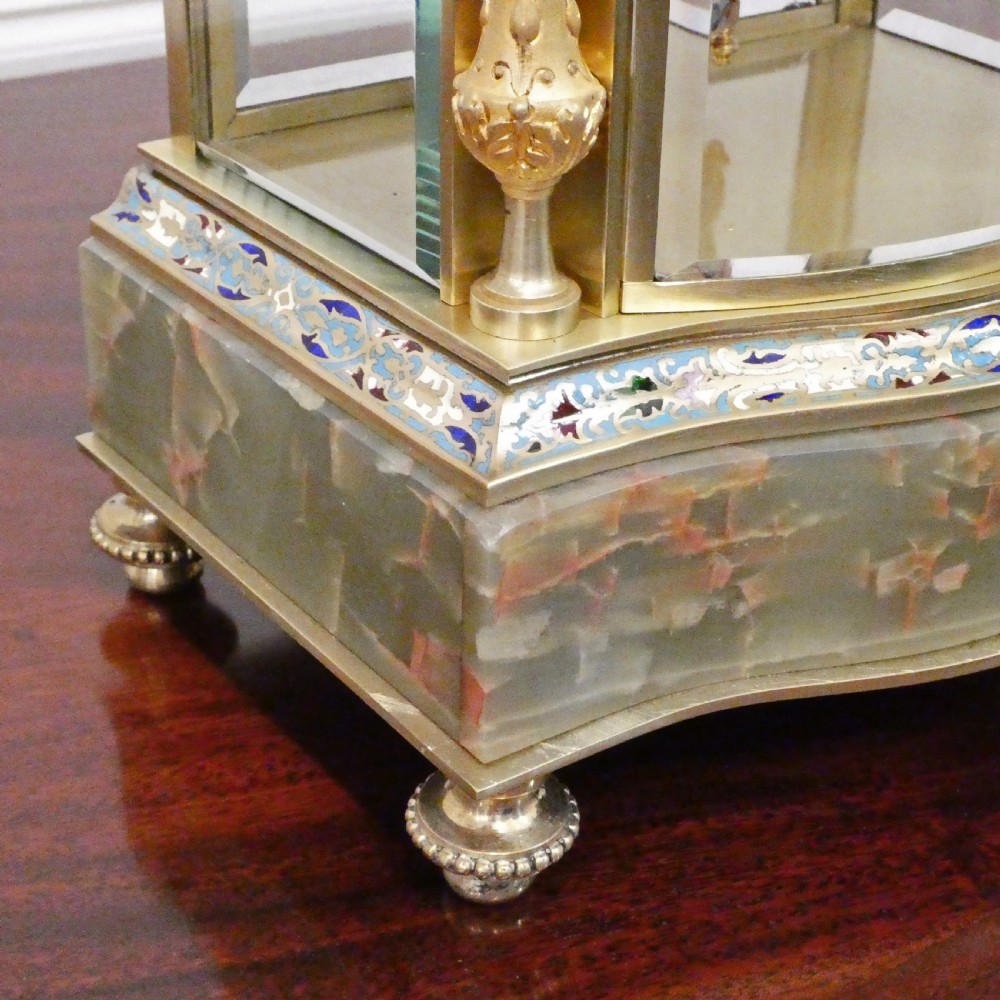 An antique French four-glass mantel clock featuring green onyx bases, champleve enamel columns, and a visible brass movement. View IV