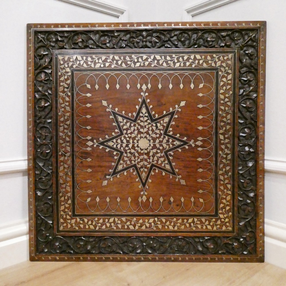 A late 19th-century square Anglo-Indian side table featuring brass inlay with a central star motif and pierced carved wood aprons. View II