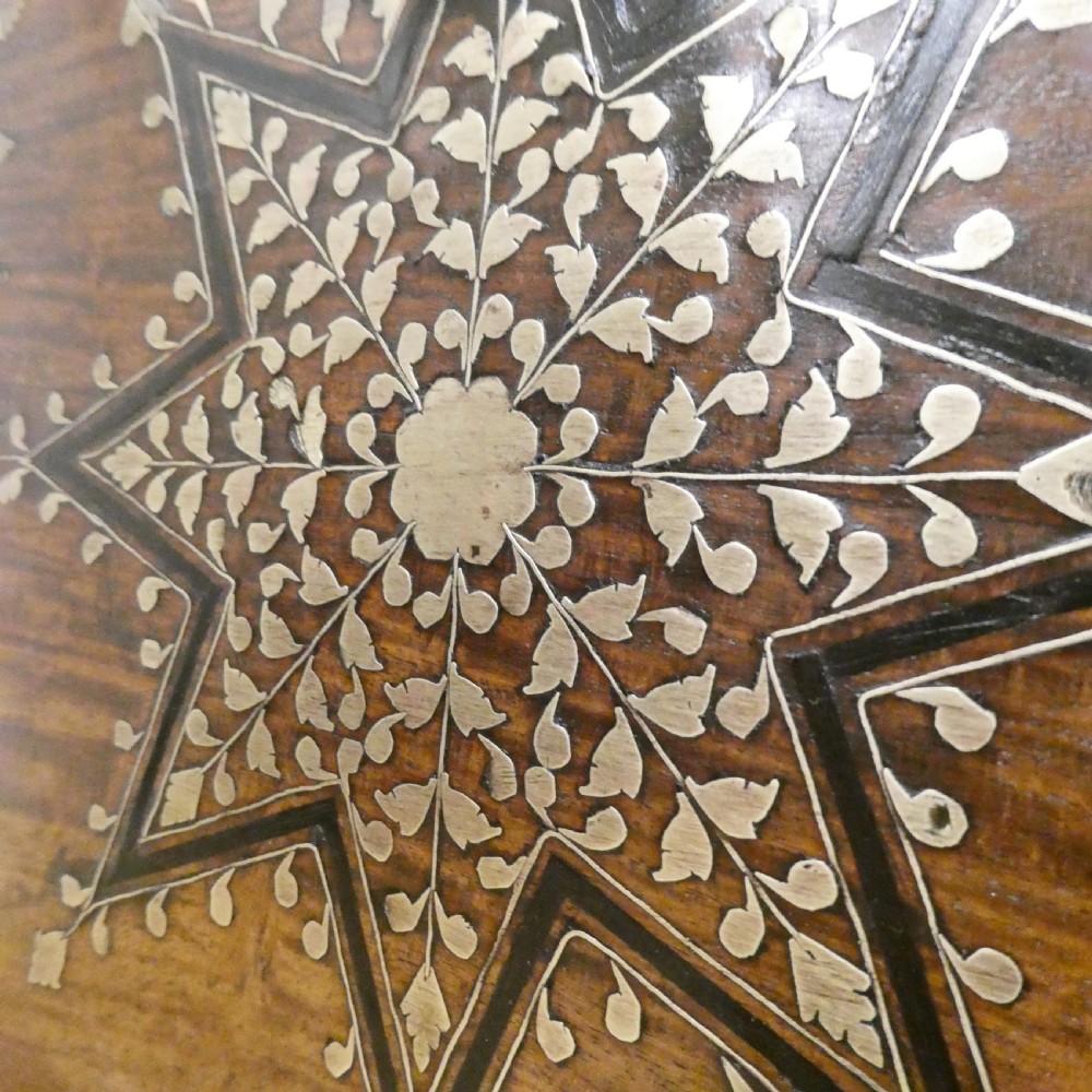 A late 19th-century square Anglo-Indian side table featuring brass inlay with a central star motif and pierced carved wood aprons. View IV