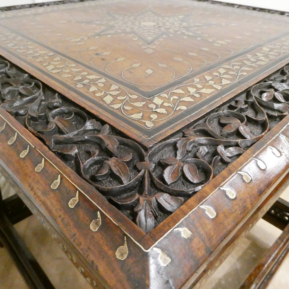 A late 19th-century square Anglo-Indian side table featuring brass inlay with a central star motif and pierced carved wood aprons. View VII