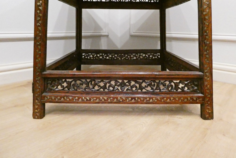 A late 19th-century square Anglo-Indian side table featuring brass inlay with a central star motif and pierced carved wood aprons. View XIV