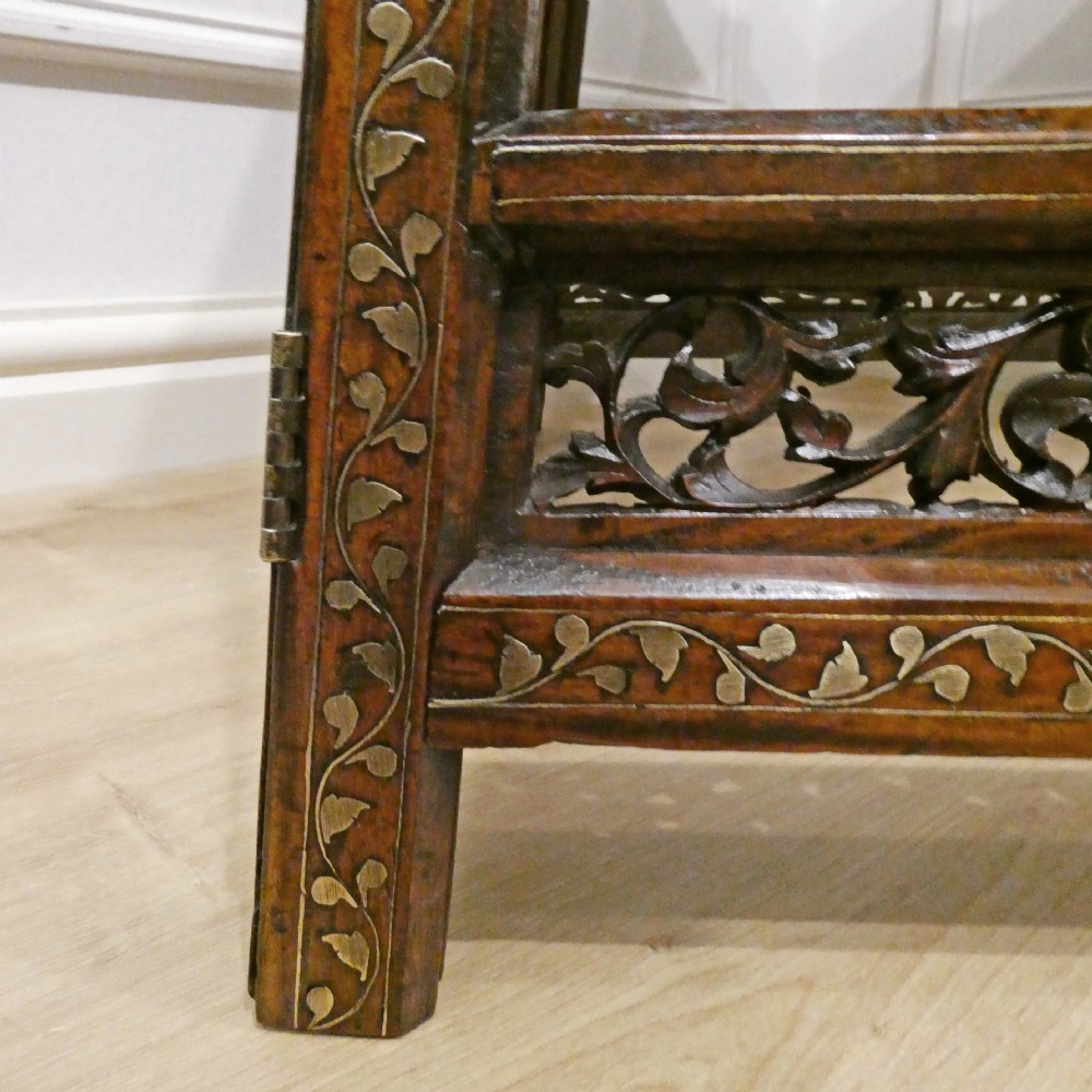 A late 19th-century square Anglo-Indian side table featuring brass inlay with a central star motif and pierced carved wood aprons. View XVI