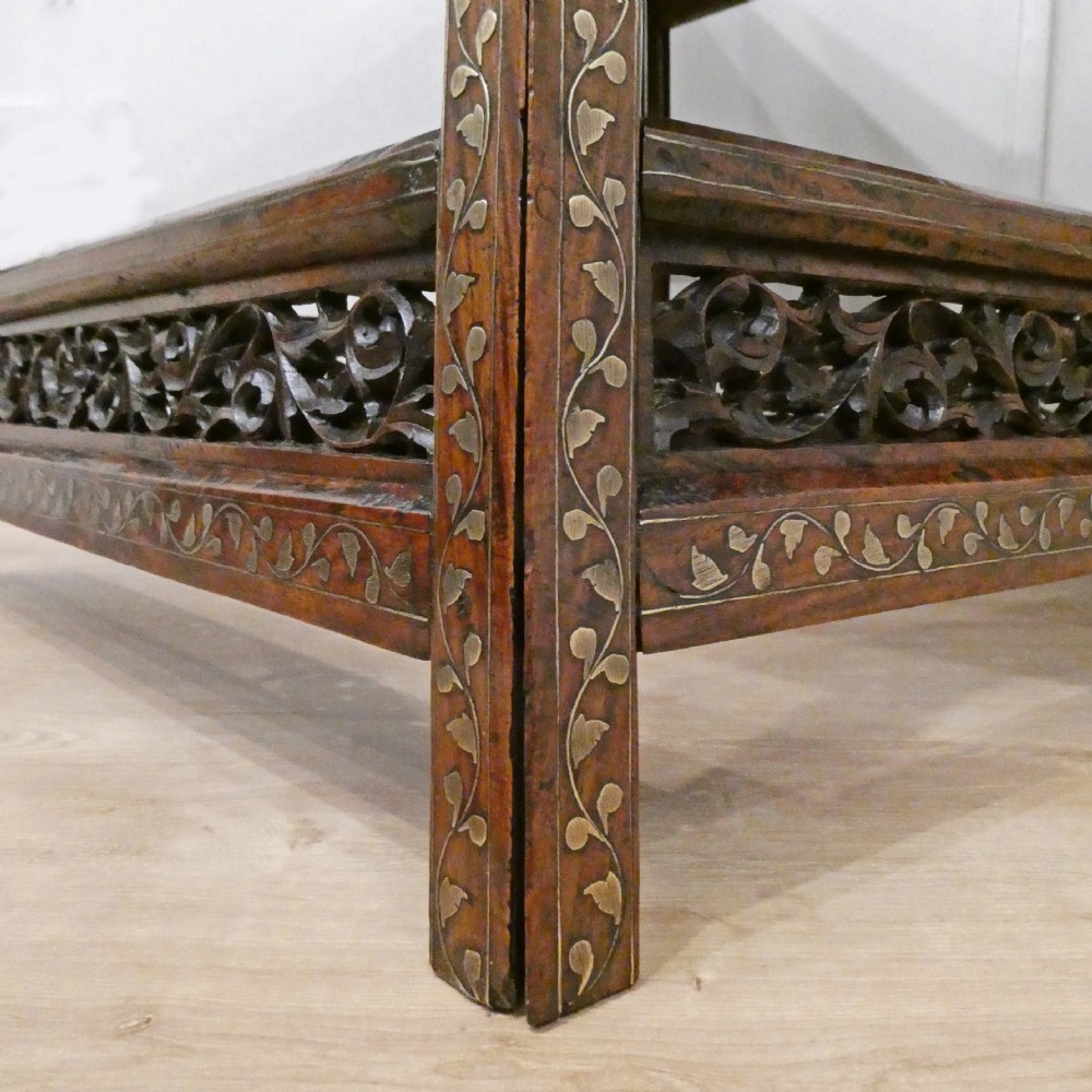 A late 19th-century square Anglo-Indian side table featuring brass inlay with a central star motif and pierced carved wood aprons. View XVII