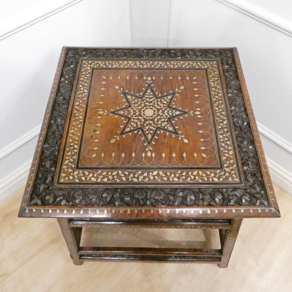 A late 19th-century square Anglo-Indian side table featuring brass inlay with a central star motif and pierced carved wood aprons. View XVIII