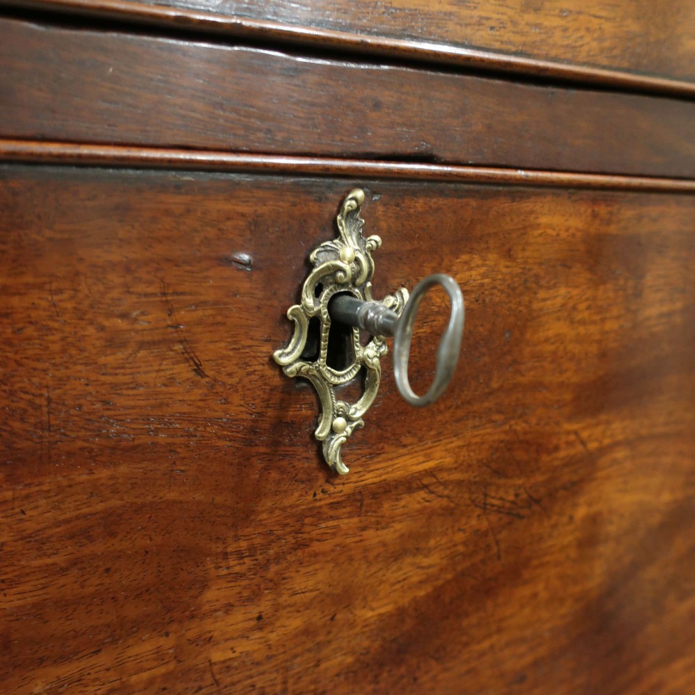 A Georgian Chippendale period mahogany chest on chest featuring two upper short drawers over five long drawers with brass swan-neck handles and carved bracket feet. View III