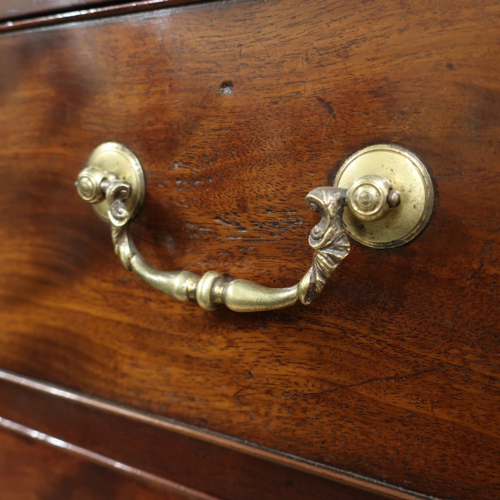 A Georgian Chippendale period mahogany chest on chest featuring two upper short drawers over five long drawers with brass swan-neck handles and carved bracket feet. View IV
