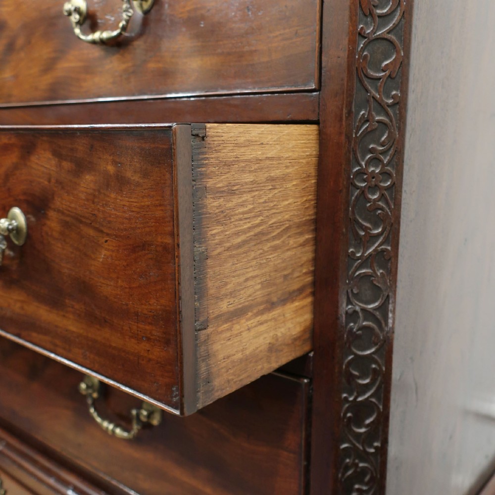A Georgian Chippendale period mahogany chest on chest featuring two upper short drawers over five long drawers with brass swan-neck handles and carved bracket feet. View VIII