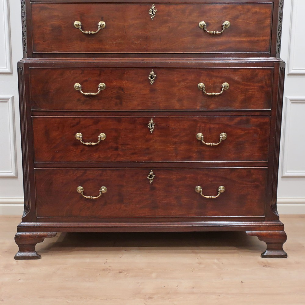 A Georgian Chippendale period mahogany chest on chest featuring two upper short drawers over five long drawers with brass swan-neck handles and carved bracket feet. View IX