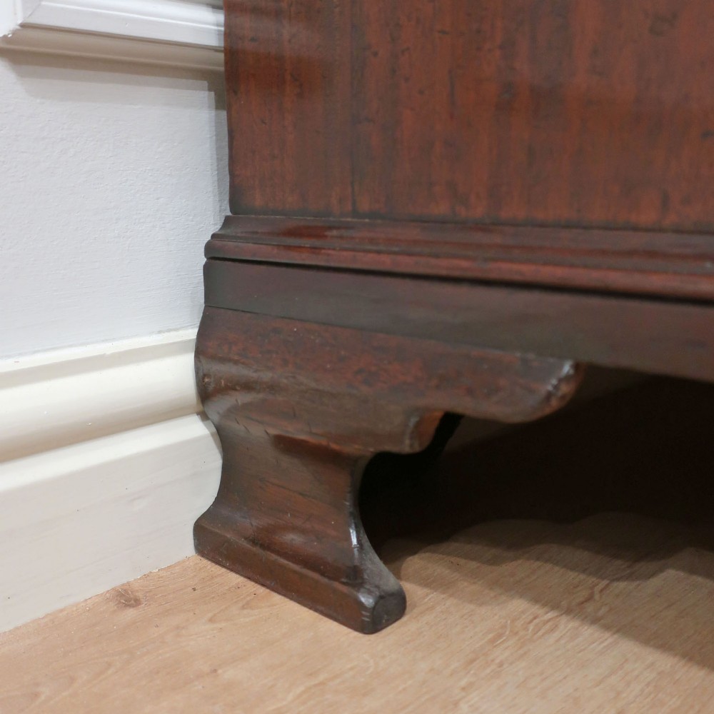 A Georgian Chippendale period mahogany chest on chest featuring two upper short drawers over five long drawers with brass swan-neck handles and carved bracket feet. View XII