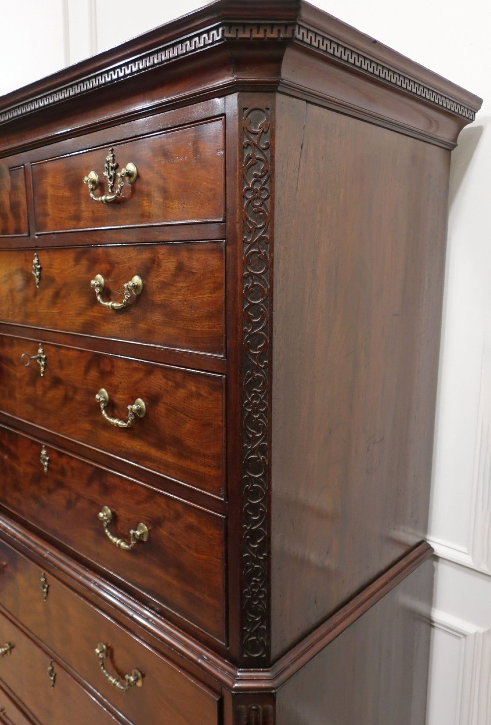 A Georgian Chippendale period mahogany chest on chest featuring two upper short drawers over five long drawers with brass swan-neck handles and carved bracket feet. View XIII