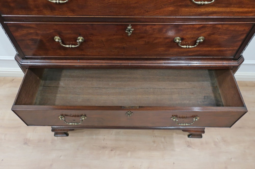 A Georgian Chippendale period mahogany chest on chest featuring two upper short drawers over five long drawers with brass swan-neck handles and carved bracket feet. View XV