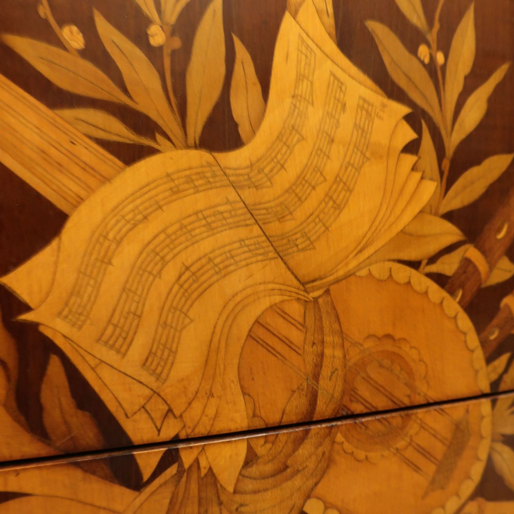 A French Louis XVI style marquetry chest of drawers featuring inlaid central medallion motifs, gilded bronze handles, tapered legs, and a fitted marble top. View III