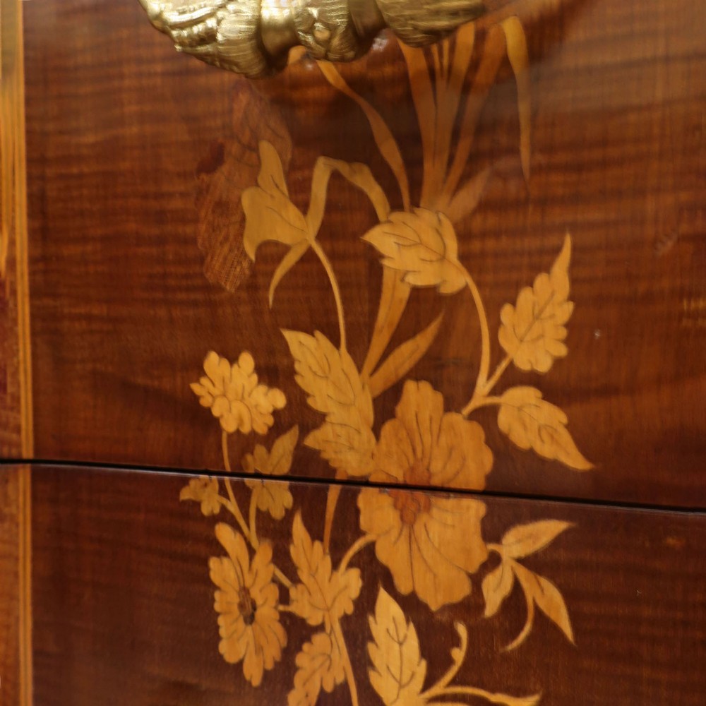 A French Louis XVI style marquetry chest of drawers featuring inlaid central medallion motifs, gilded bronze handles, tapered legs, and a fitted marble top. View VIII