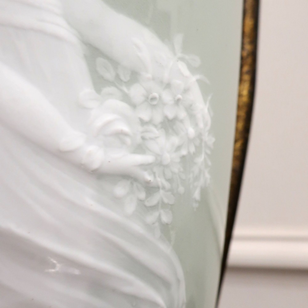 A French Neoclassical style table lamp featuring a pale green pate-sur-pate porcelain urn base, dark bronze side handles, and a pleated cream shade. View V