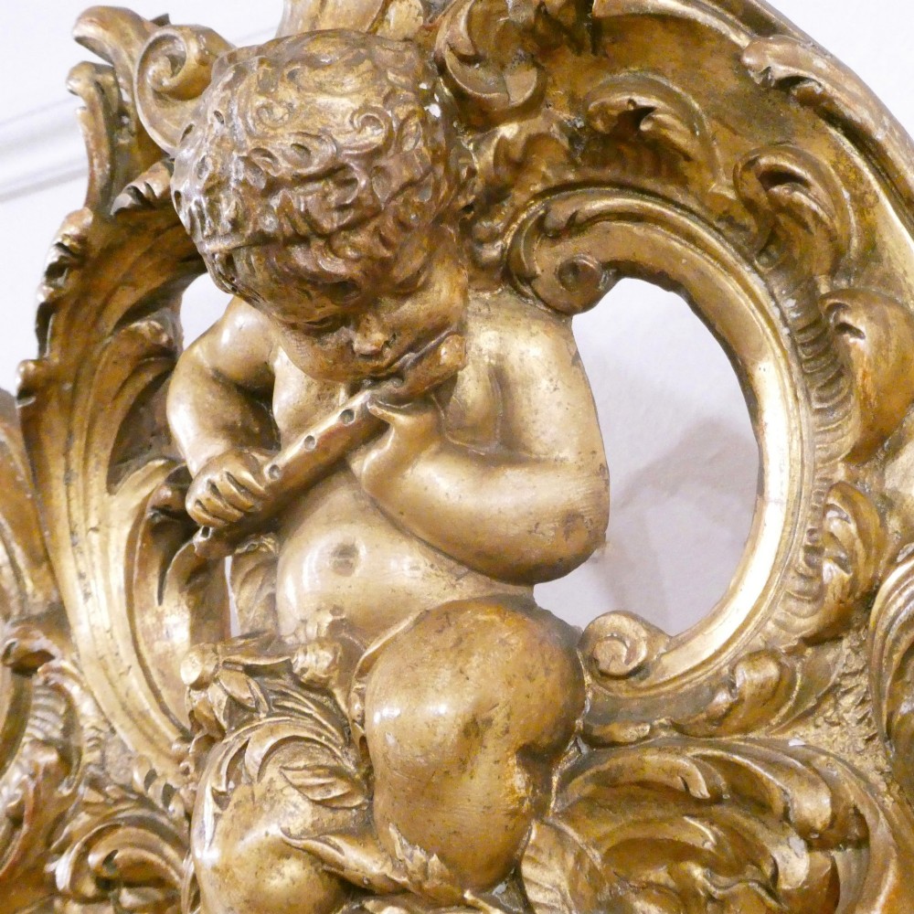 A 19th-century French Louis XVI style gilded wall mirror featuring a carved decorative crest and beaded frame border. View XIV