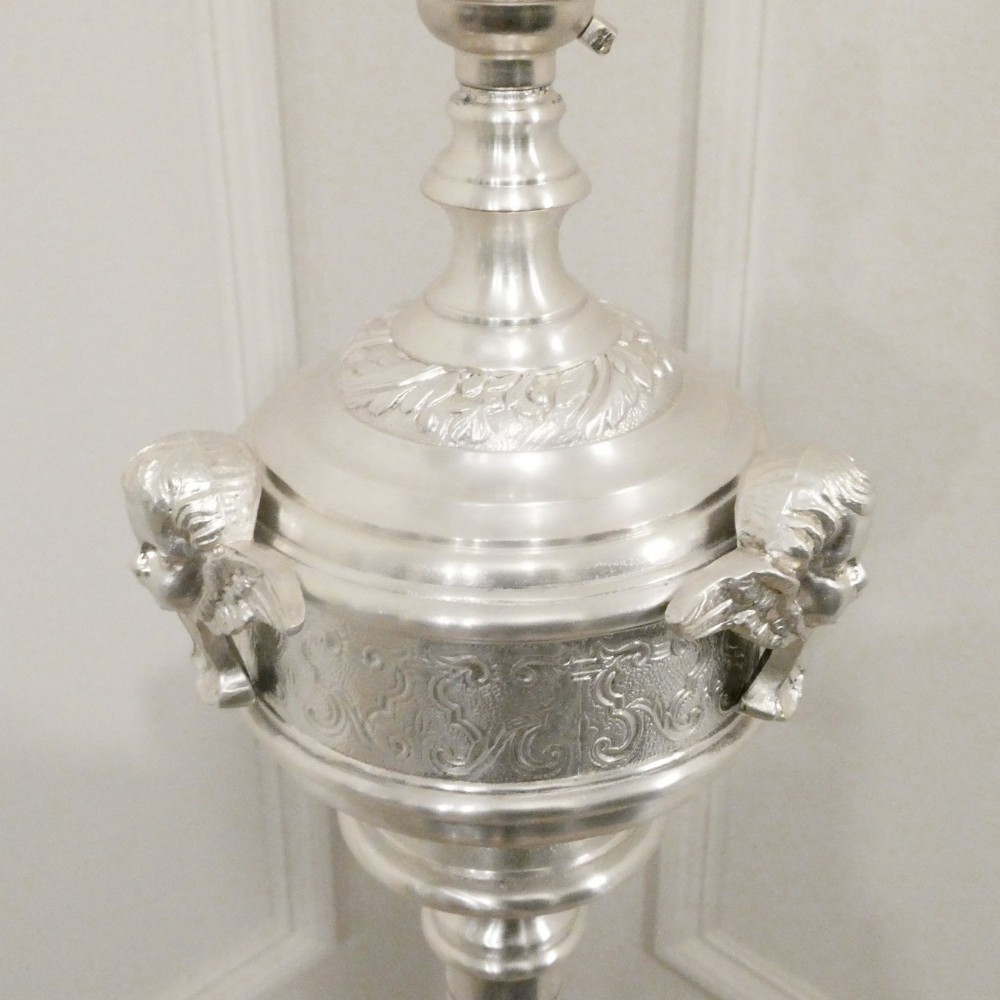 An early 20th-century silver-plated standard lamp featuring a turned column, cast base, and a cream scalloped lampshade with fringe detailing. View IV