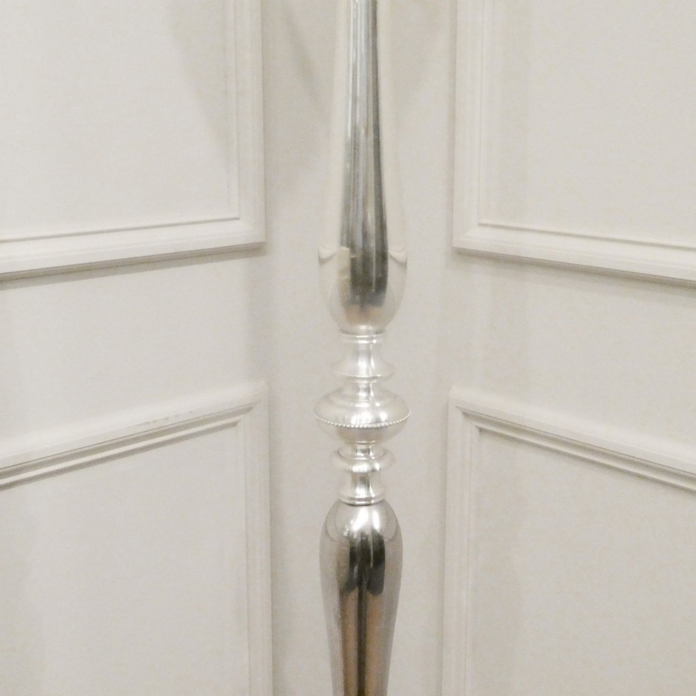 An early 20th-century silver-plated standard lamp featuring a turned column, cast base, and a cream scalloped lampshade with fringe detailing. View V
