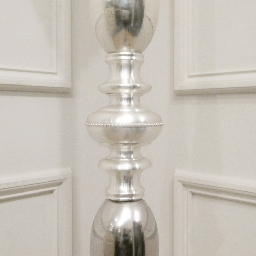 An early 20th-century silver-plated standard lamp featuring a turned column, cast base, and a cream scalloped lampshade with fringe detailing. View VI