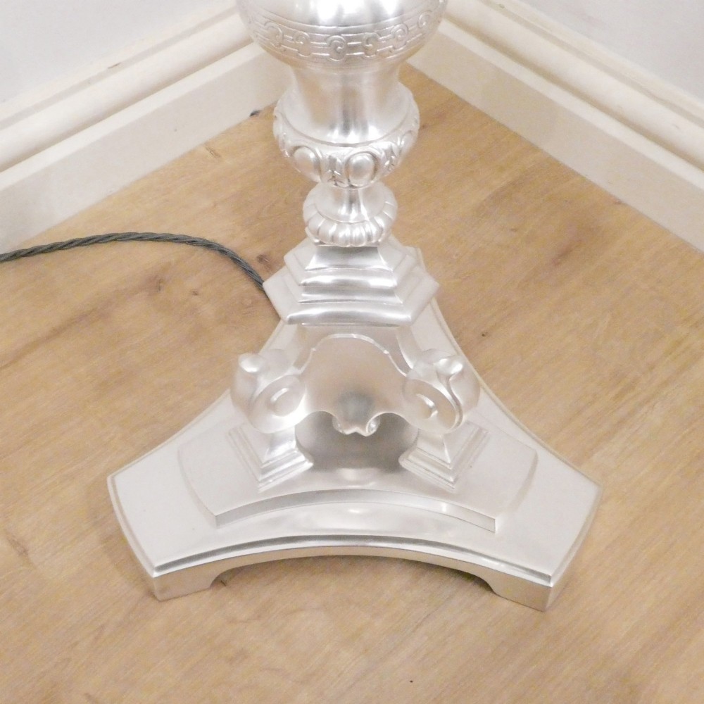 An early 20th-century silver-plated standard lamp featuring a turned column, cast base, and a cream scalloped lampshade with fringe detailing. View VII
