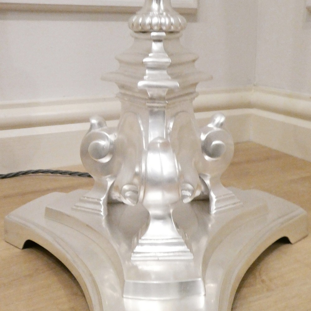 An early 20th-century silver-plated standard lamp featuring a turned column, cast base, and a cream scalloped lampshade with fringe detailing. View IX
