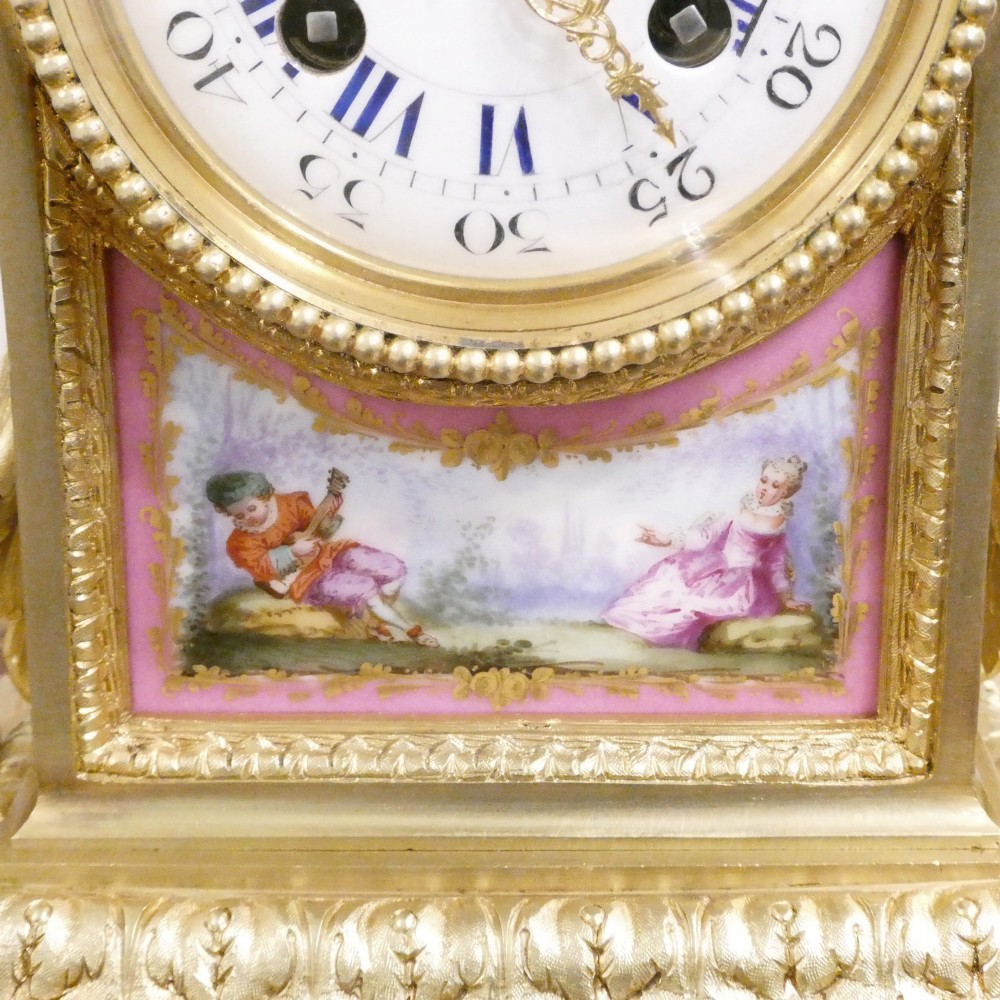 A Louis XVI style gilt bronze mantel clock featuring hand-painted pink porcelain panels and an urn-shaped finial. View III