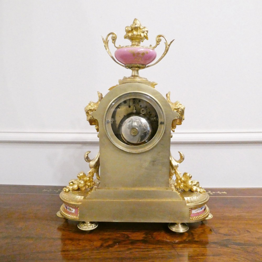 A Louis XVI style gilt bronze mantel clock featuring hand-painted pink porcelain panels and an urn-shaped finial. View XI