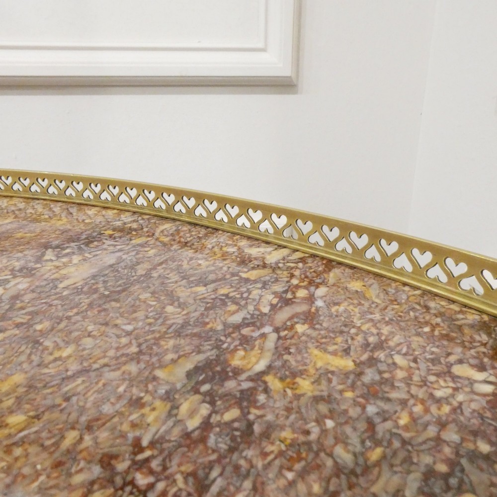 A French Louis XVI style kidney-shaped mahogany side table featuring a marble top, pierced brass gallery, lower undertier, and elaborate gilt-bronze mounts. View VI