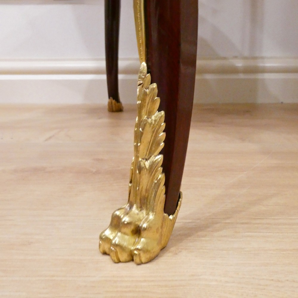 A French Louis XVI style kidney-shaped mahogany side table featuring a marble top, pierced brass gallery, lower undertier, and elaborate gilt-bronze mounts. View VIII
