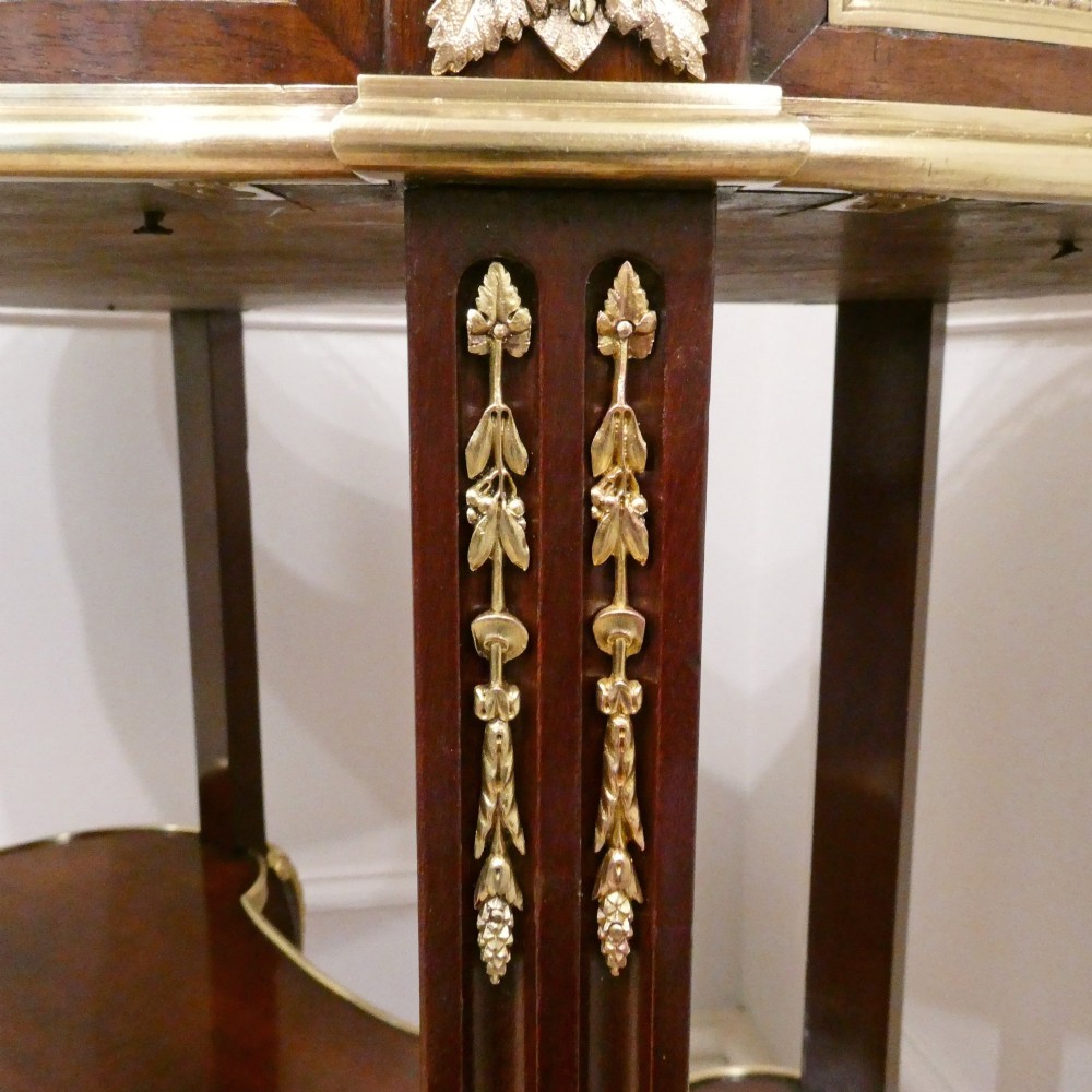 A French Louis XVI style kidney-shaped mahogany side table featuring a marble top, pierced brass gallery, lower undertier, and elaborate gilt-bronze mounts. View XIII