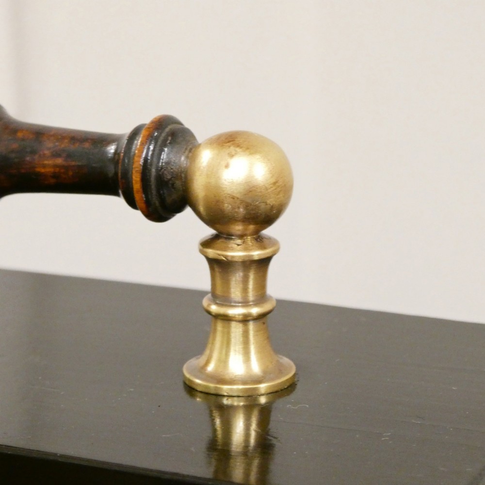 An Edwardian rectangular ebonised wooden mantel clock and barometer unit with twin white circular dials set into a scroll-engraved brass plate. View VII
