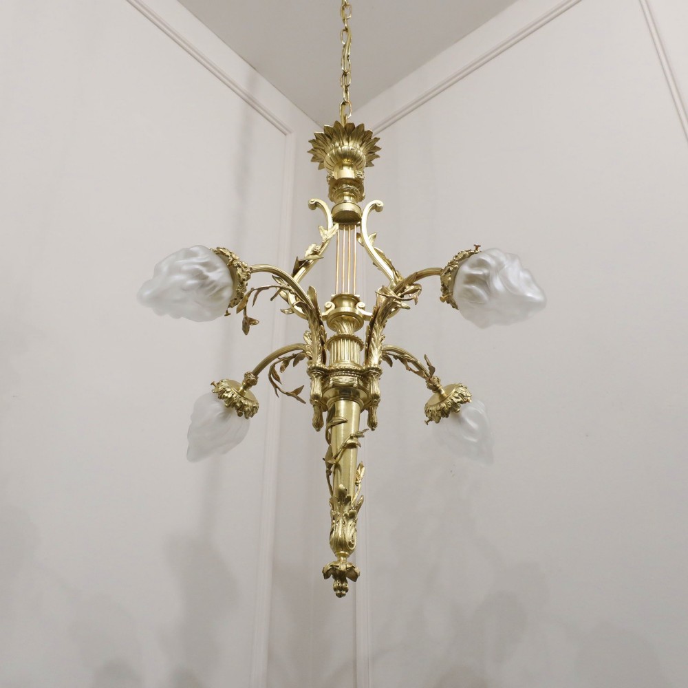 A French Neoclassical style gilt bronze chandelier featuring a central lyre-shaped stem and two outward-curving arms with frosted glass shades. View III