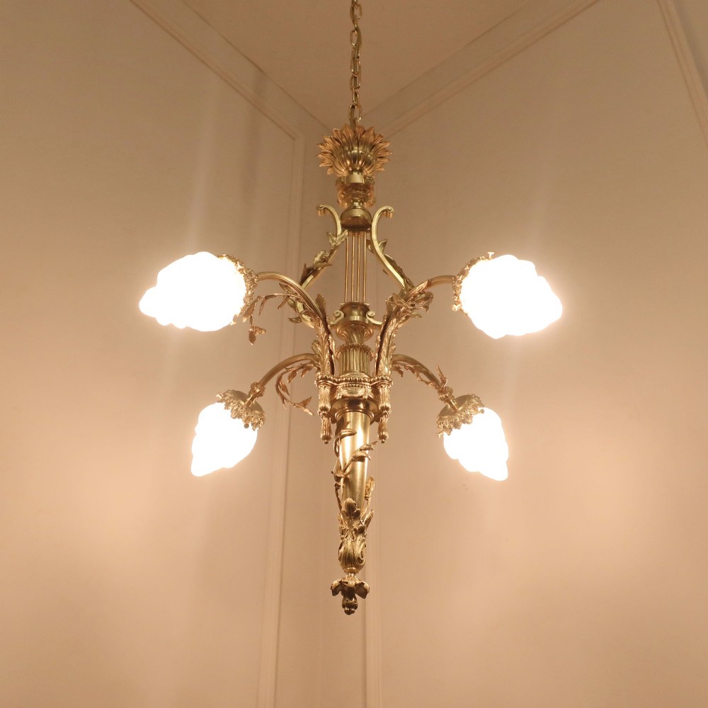 A French Neoclassical style gilt bronze chandelier featuring a central lyre-shaped stem and two outward-curving arms with frosted glass shades. View IV