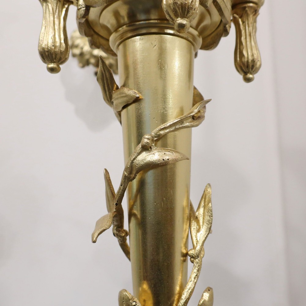 A French Neoclassical style gilt bronze chandelier featuring a central lyre-shaped stem and two outward-curving arms with frosted glass shades. View XII