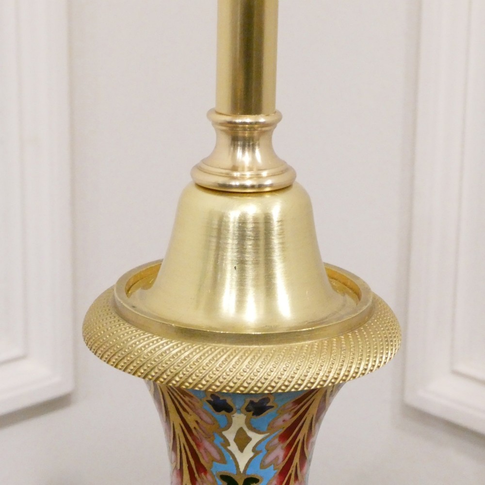 A pair of French table lamps featuring urn-shaped green onyx columns detailed with polychrome champleve enamelling and topped with pleated white shades. View IV