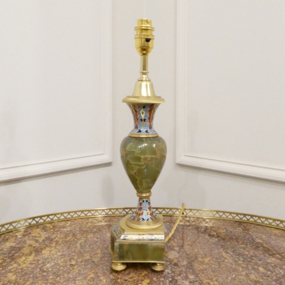 A pair of French table lamps featuring urn-shaped green onyx columns detailed with polychrome champleve enamelling and topped with pleated white shades. View IX