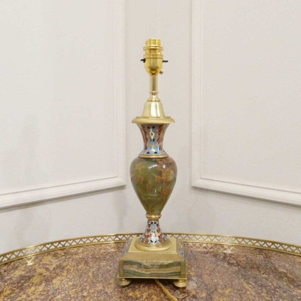 A pair of French table lamps featuring urn-shaped green onyx columns detailed with polychrome champleve enamelling and topped with pleated white shades. View X