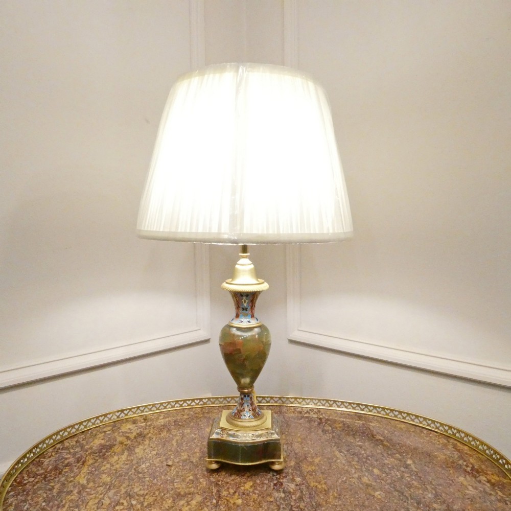 A pair of French table lamps featuring urn-shaped green onyx columns detailed with polychrome champleve enamelling and topped with pleated white shades. View XII