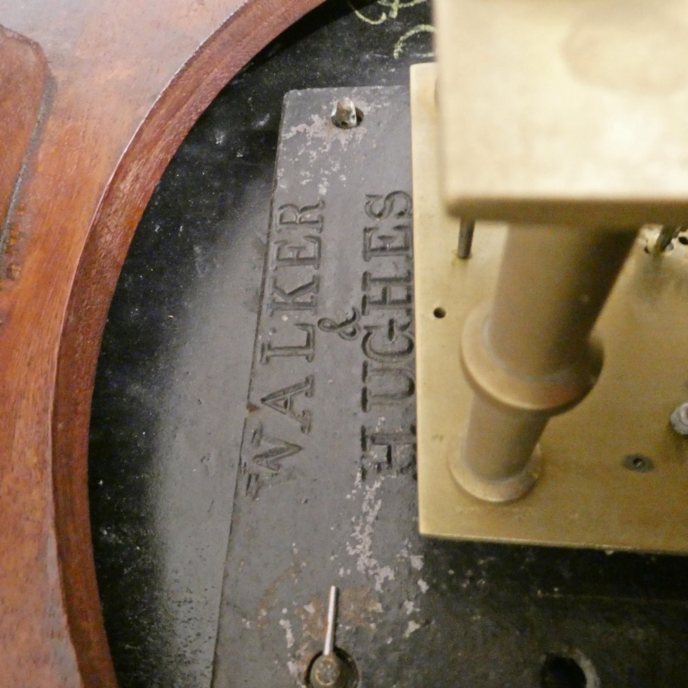 A circular Georgian wall clock featuring a cream dial with black Roman numerals, blued steel hands, a polished brass bezel, and a dark mahogany wood surround. View VIII