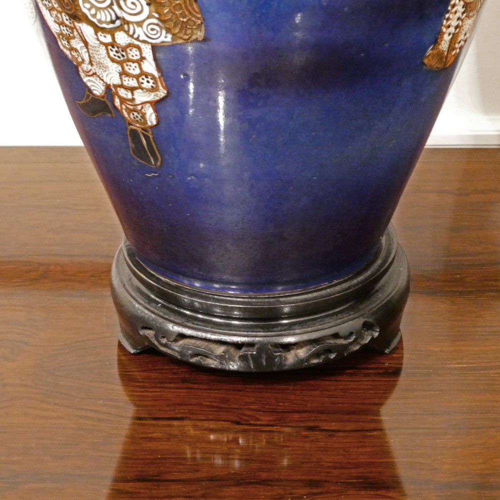 A pair of cobalt blue Japanese Satsuma porcelain table lamps decorated with gilded hand-painted figures and fitted with brass mountings and a cream pleated shade. View V
