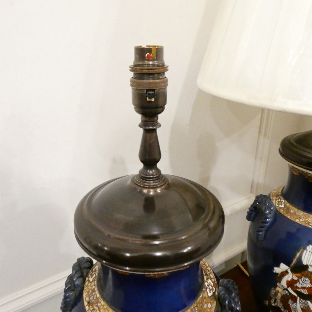 A pair of cobalt blue Japanese Satsuma porcelain table lamps decorated with gilded hand-painted figures and fitted with brass mountings and a cream pleated shade. View VI