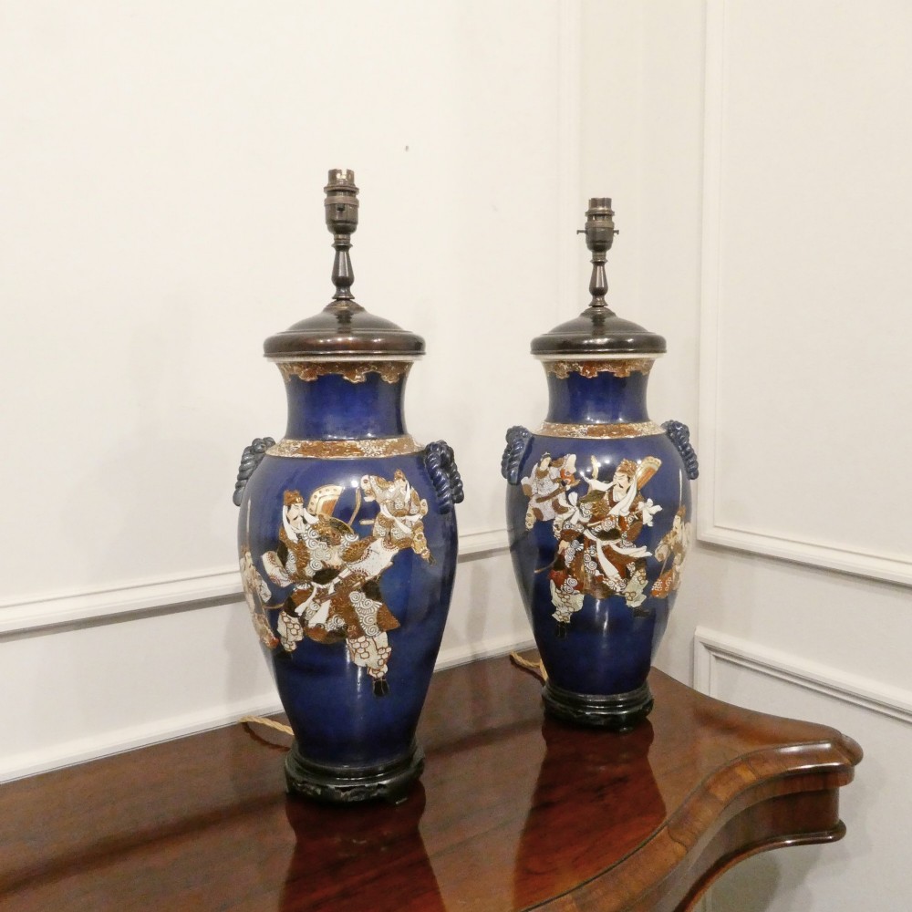 A pair of cobalt blue Japanese Satsuma porcelain table lamps decorated with gilded hand-painted figures and fitted with brass mountings and a cream pleated shade. View VII