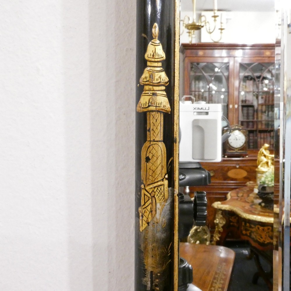 An arched wall mirror with a dark lacquered frame featuring gilded Chinoiserie motifs and segmented glass plates. View II