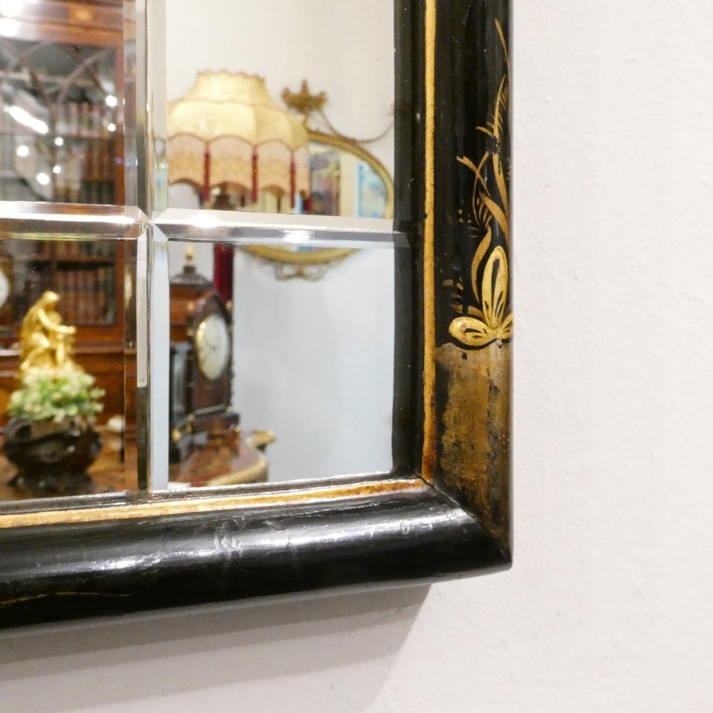 An arched wall mirror with a dark lacquered frame featuring gilded Chinoiserie motifs and segmented glass plates. View VI